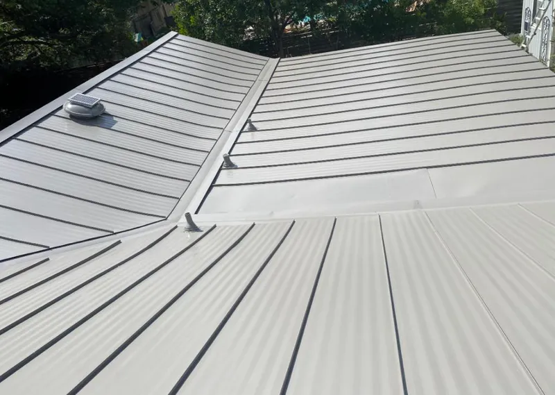 Solar attic fan installed on a metal roof for Roof Ventilation in Ione